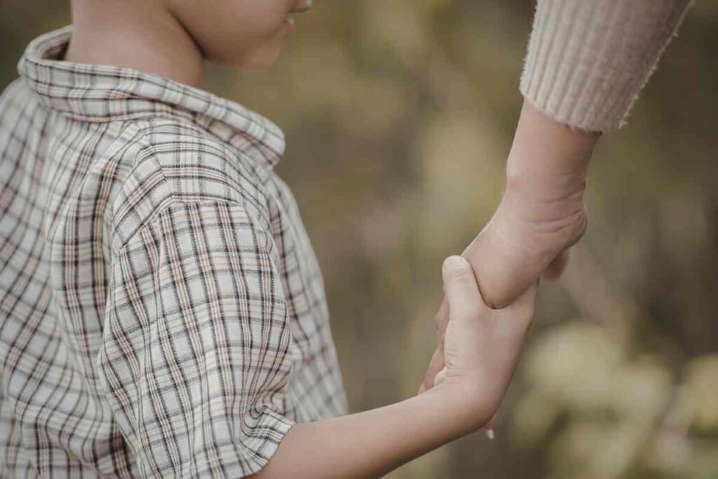 mano di bambino stringe mano di adulto