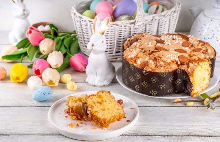 colomba pasquale intera e una fetta tagliata nel piatto